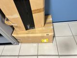 boxes stacked on top of each other on the floor in front of a blue wall