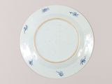 a blue and white plate with blue flowers on it