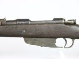 an old gun that is on display on a white surface