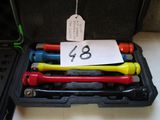 four different colored tools in a case with a price tag on it