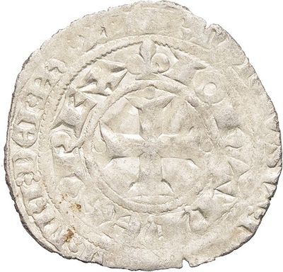 a white coin with a circular design on it