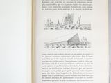 an open book with a drawing of a city on it