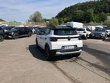 a white car parked in a parking lot next to other cars