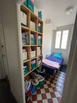 a room with a bed and a book shelf in it