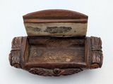 a wooden box with a lid on a white surface