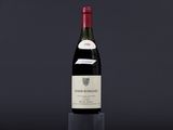 a bottle of wine sitting on top of a black table