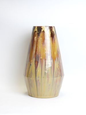 a vase that is sitting on a white surface