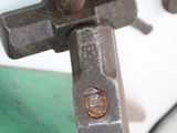 a close up of a metal object with a cross on it