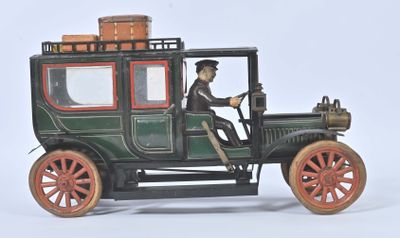 a green toy car with a man sitting in the driver ' s seat