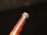 a close up of a person holding a pen in their hand