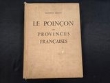 an old book sitting on top of a black cloth covered table