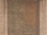 an old photo of a door in a stone building