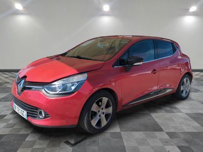 the red car is parked on a checkered floor in the garage
