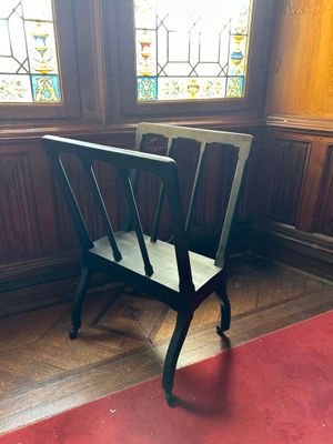 une chaise dans un coin d'une pièce aux vitraux colorés