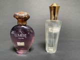 two bottles of perfume sitting next to each other on a table