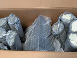 a cardboard box filled with bags of toilet paper