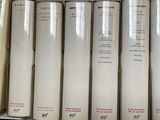 several books are stacked on a shelf in a book store