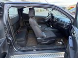 the interior of a car with the door open and the passenger seat down