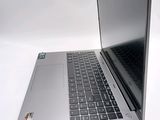 a silver laptop with a black keyboard on a white surface