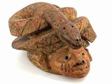 a wooden sculpture of two snakes on top of each other