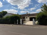 an image of a house with a gate and a driveway
