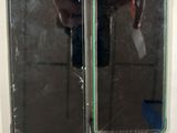 two mirrors on the wall with a person taking a picture of them