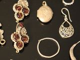 many different types of jewelry displayed on a black tray