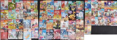 a lot of comic books on display on the wall