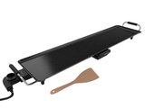 an image of a grill with a spatula on it