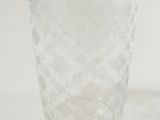 a clear glass vase sitting on a white surface