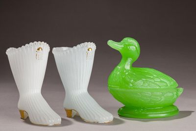 three green and white vases sitting next to each other on a table