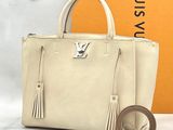 louis vuitton beige leather handbag with tassels and a belt