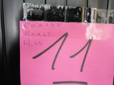 a pink sign with the number 14 on it in front of a black door