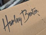 a box that has a sign on it that says harley benton