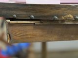 a close up of a wooden table with a piece of paper on it