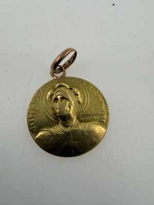 a close up of a gold medal on a white surface