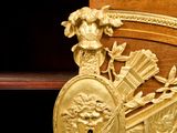 a wooden desk with a gold decoration on it