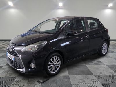 a black toyota yaris parked on a checkered floor
