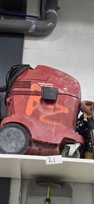 a red machine sitting on top of a white shelf