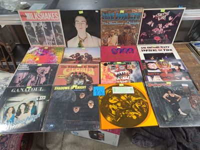 a lot of vinyl records on a table in a room