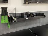 a broom and a broom holder on the counter