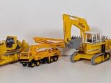 a lot of yellow construction vehicles that are lined up together