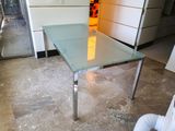 a glass table in the middle of a room