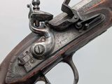 a close up of a gun that is on display on a table