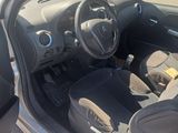 the interior of a car with the door open and a seat in the passenger seat