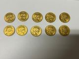 a bunch of gold coins sitting on top of a white table
