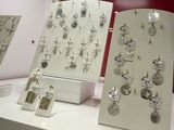 many different types of jewelry displayed on display on a table