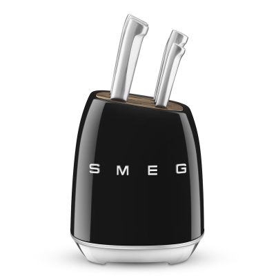 black and white image of a black toaster with two knives in it