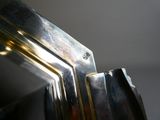 a close up of a metal object with a light coming through it