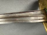 a close up of a knife on a silver plate